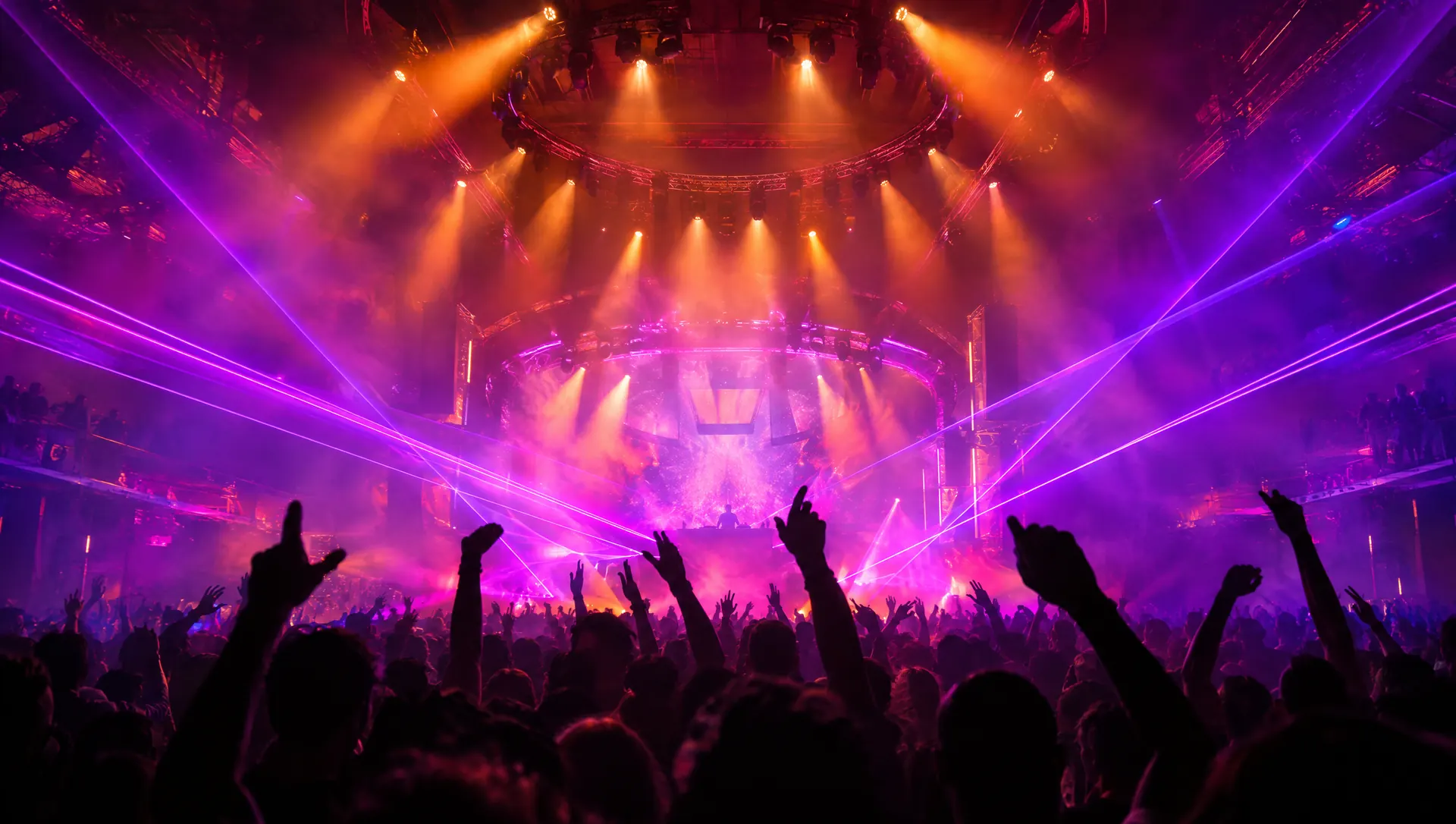 Crowd with raised hands under purple lasers at AETHER